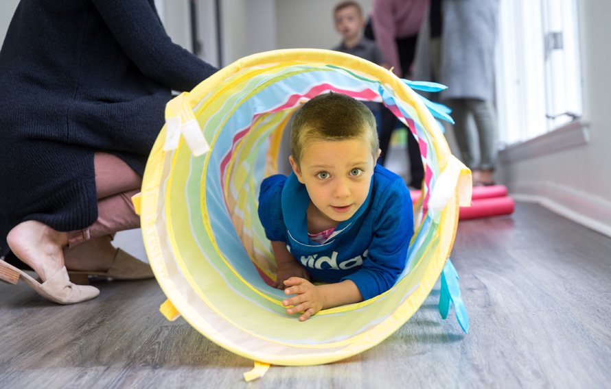 Boy climbing in tunnel