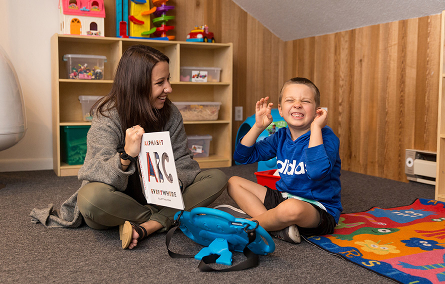 Teacher reading book to boy