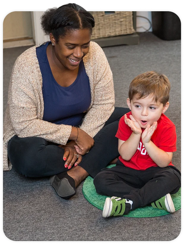 BOy with teacher on class